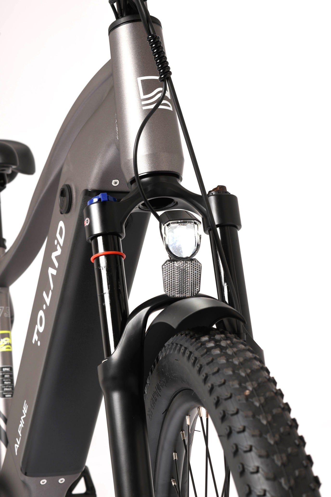 Close-up of a bicycle fork with 'TOLAND' branding on a white background