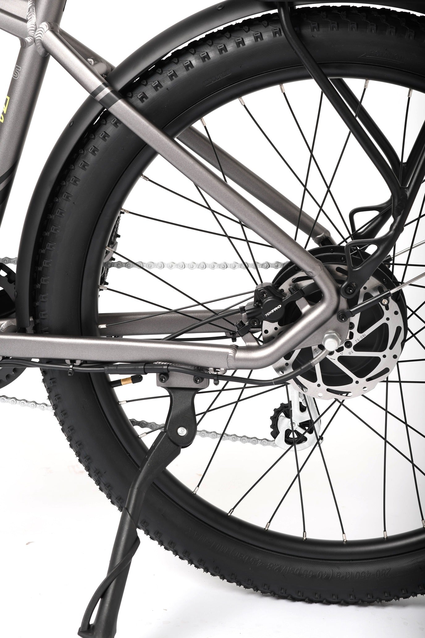 Close-up of a bicycle wheel and chain on a white background