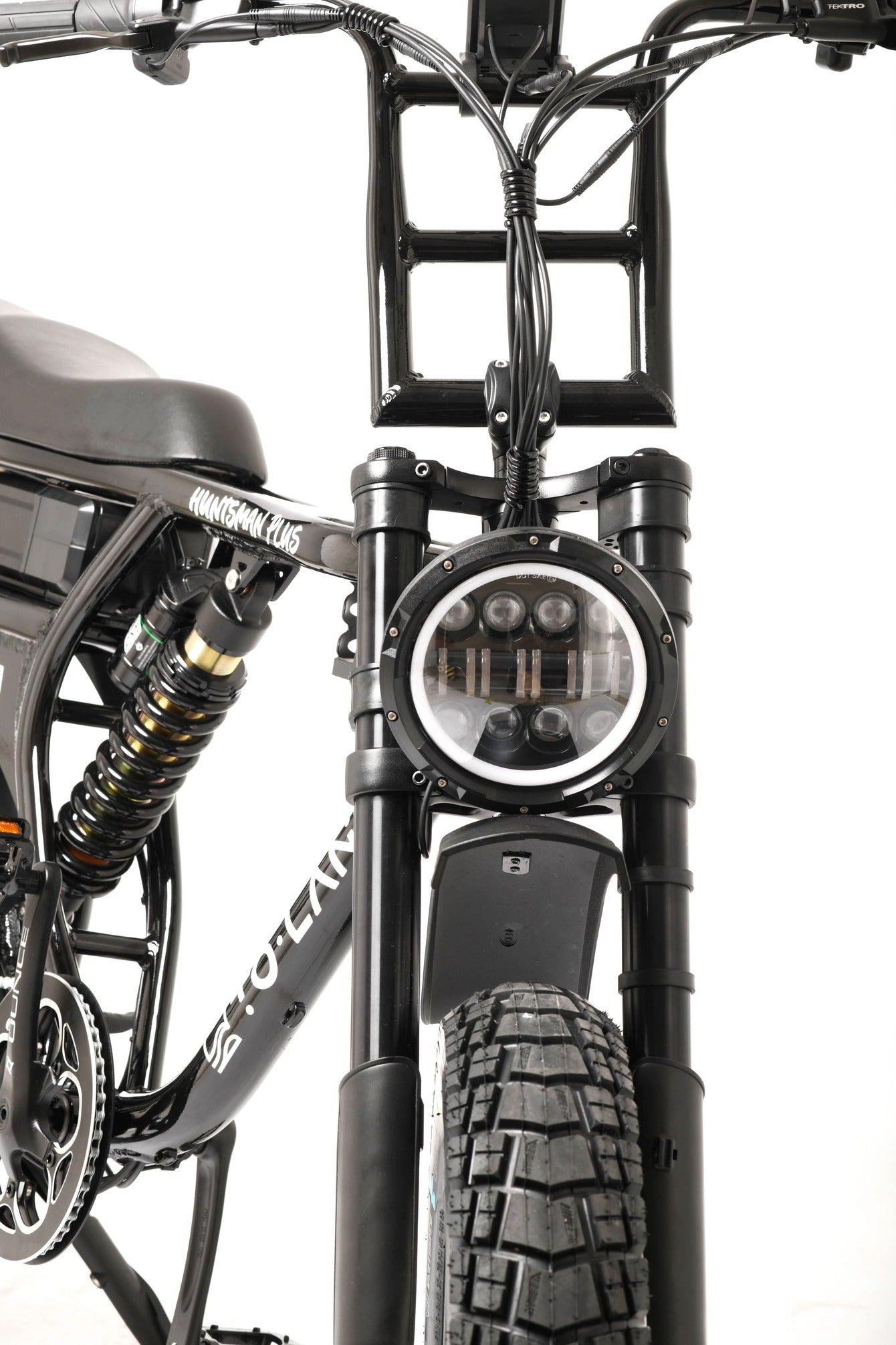 Close-up of a electric bike's front suspension and headlight on a white background