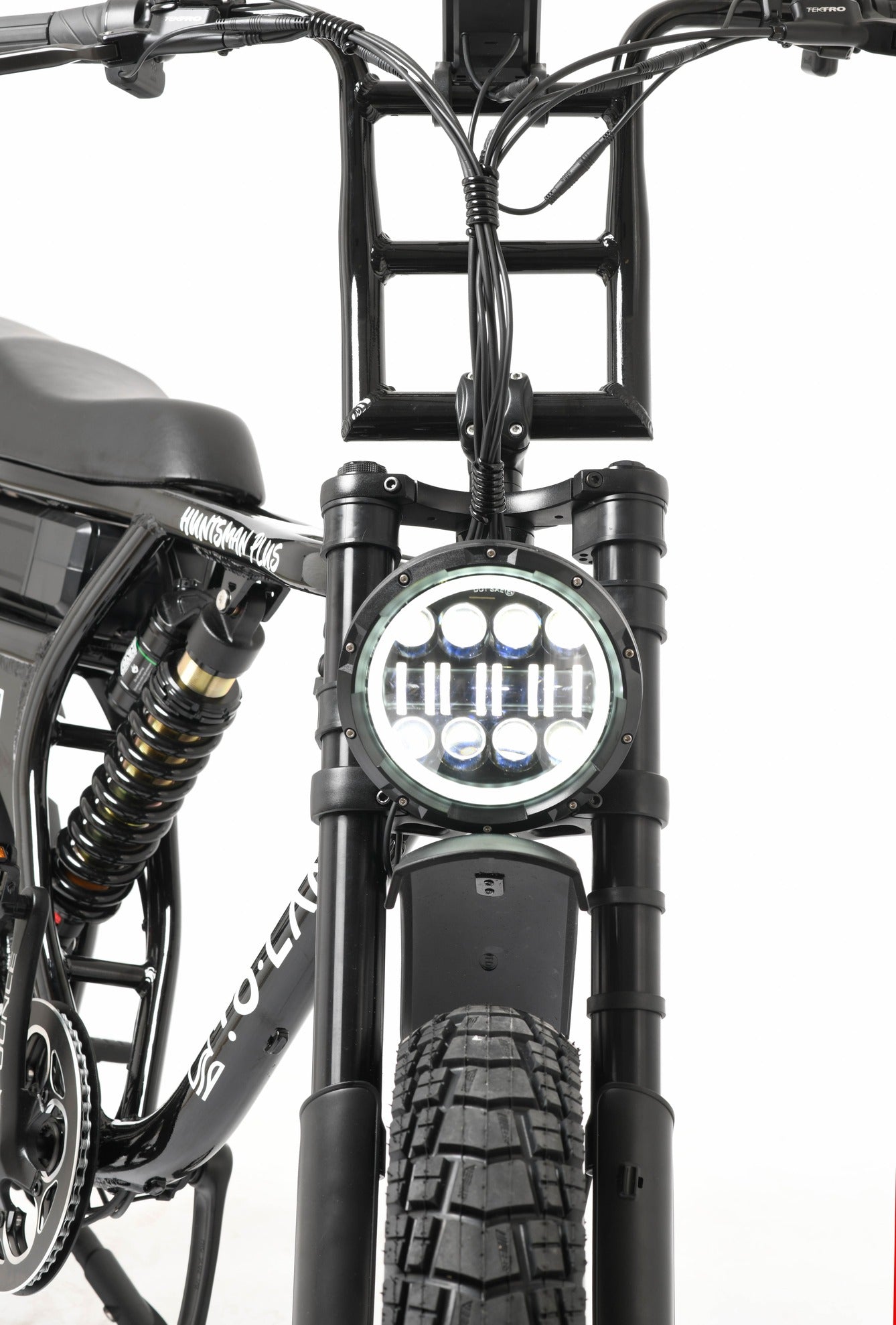 Close-up of a electric bike headlight and front wheel on a white background