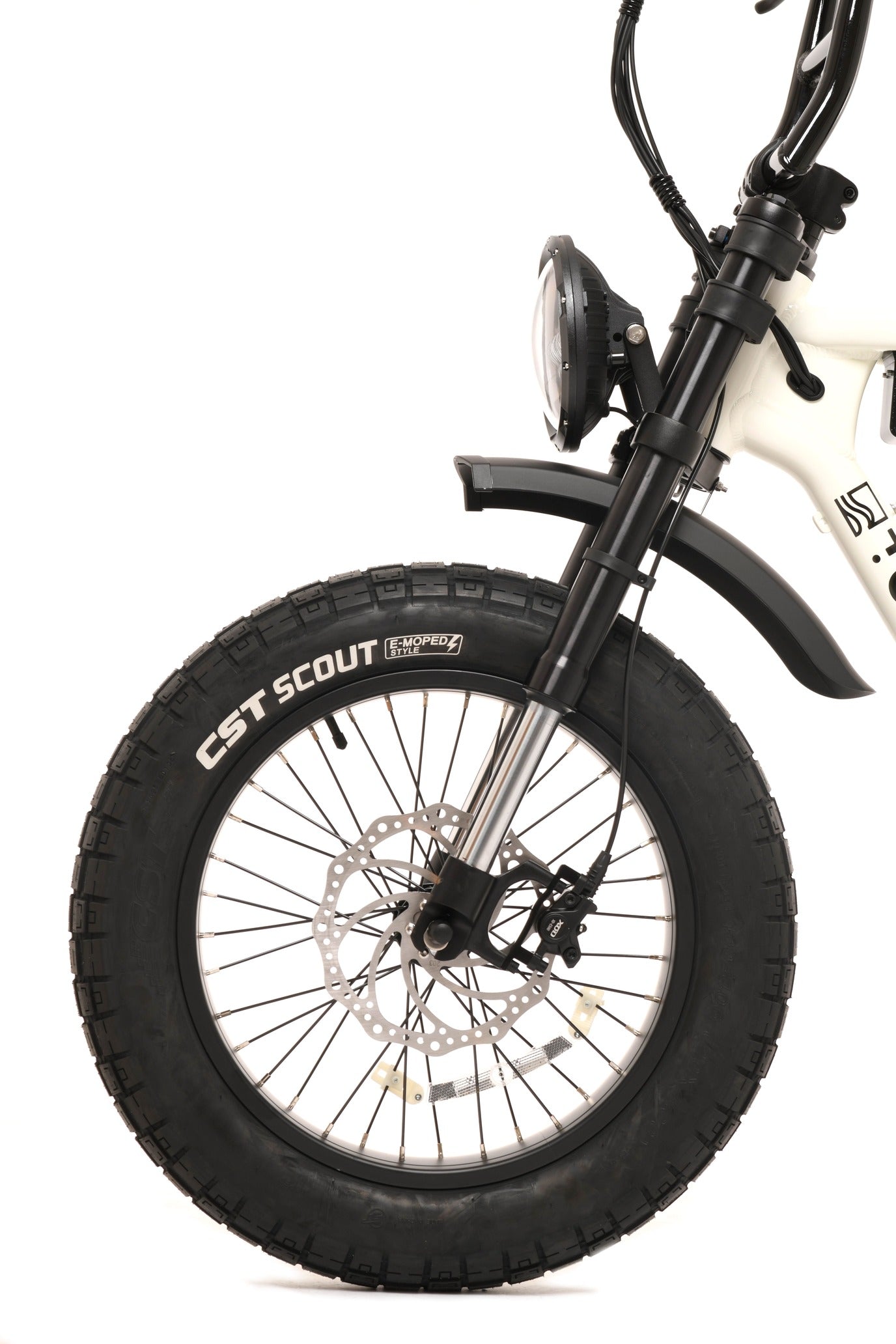 Close-up of a bicycle wheel with CST Scout tyre on a white background