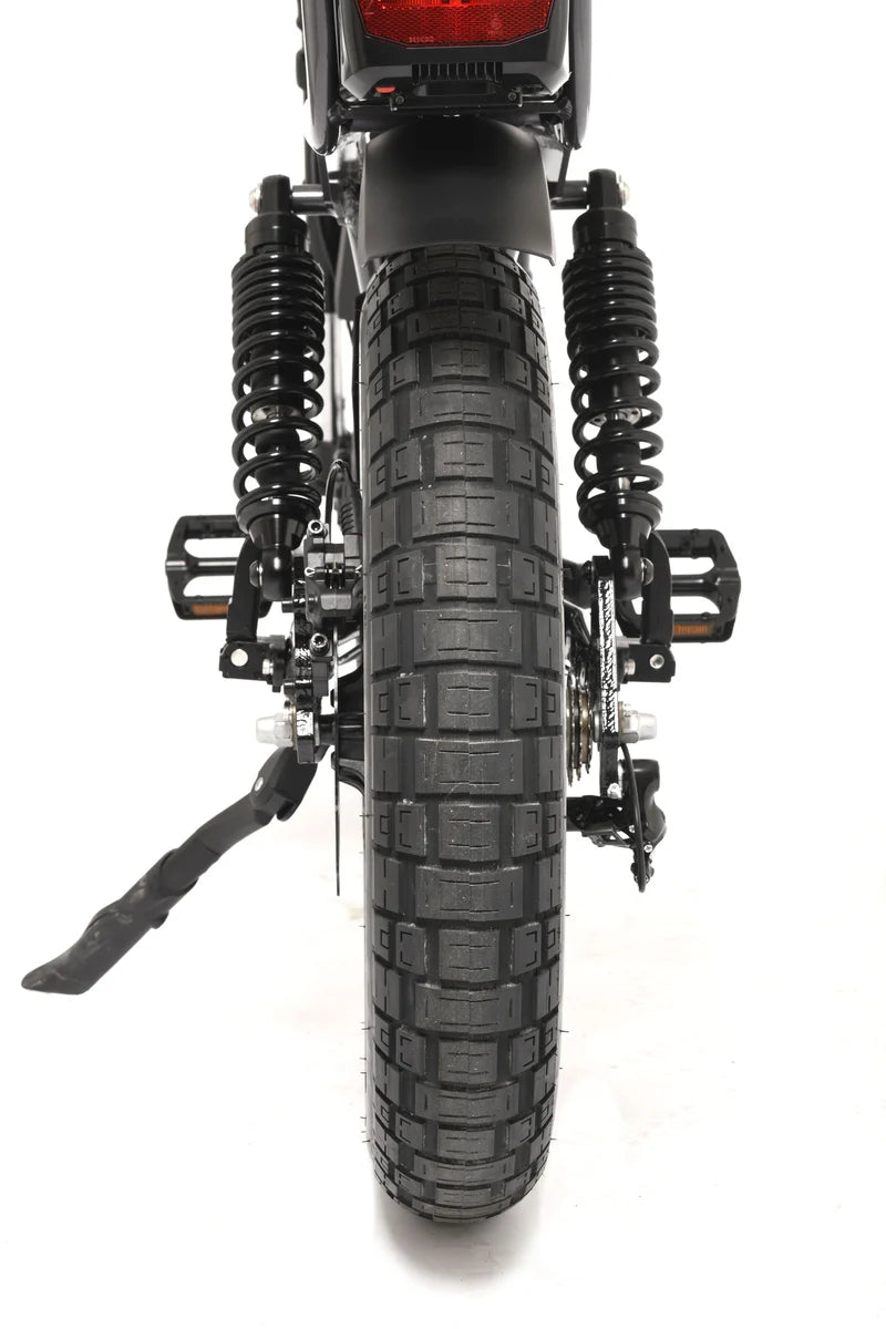 Close-up of a electric bike's rear wheel and suspension on a white background